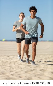 Couple Running On The Beach