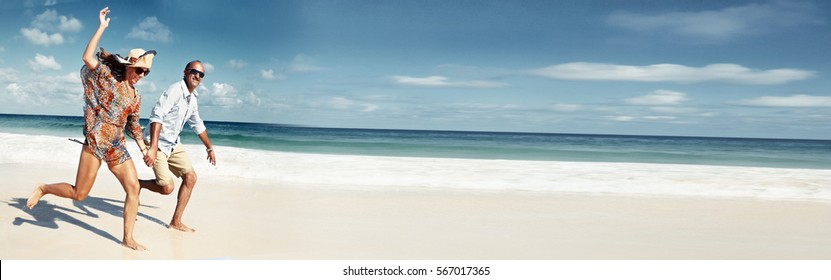 Couple Running On The Beach