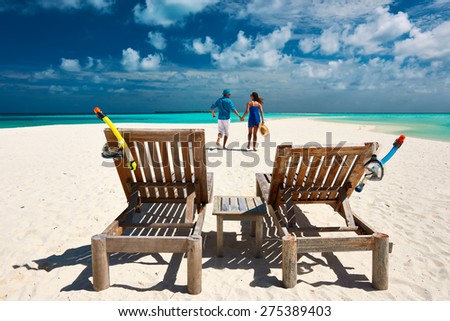 Couple running on a tropical beach at Maldives