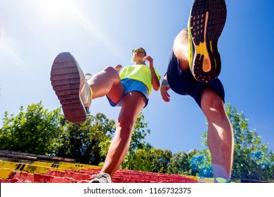 Couple With Running Sneakers On Stairs While Jogging. Staying Fit Concept Urban. Low Angle Pov