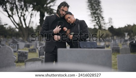 Couple, sad and mourning at tomb of graveyard, funeral and pay respect together outdoor. Death, grief and man and woman at cemetery by casket, empathy and interracial support to console at tombstone