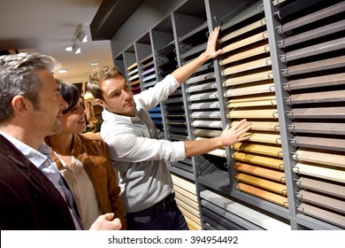 Couple with salesman in kitchen furniture store
