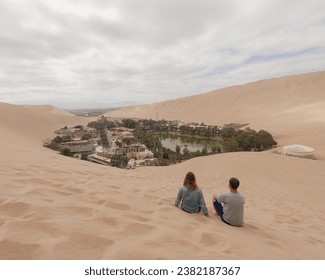 couple in sand dunes of huacachina desert in peru - Powered by Shutterstock