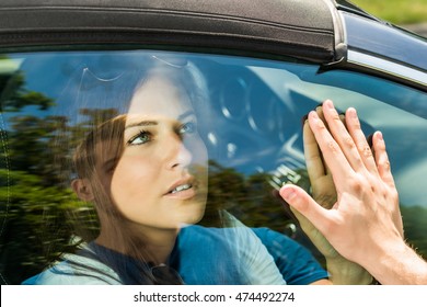 Couple Saying Goodbye Before Car Travel Through The Car Window