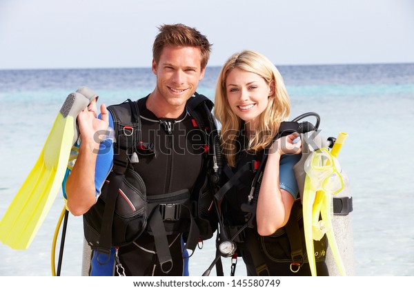 Couple\
With Scuba Diving Equipment Enjoying Beach\
Holiday