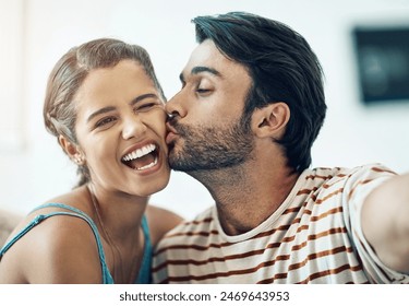 Couple, selfie and kiss in home with smile, care and love for post on social media with connection. Indian man, woman and happy with photography for profile picture, excited and laughing at apartment - Powered by Shutterstock