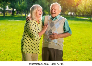 Couple Of Seniors Laughing. Old People Outdoors. Not A Day Without Laughter. Look At Everything With Humor.