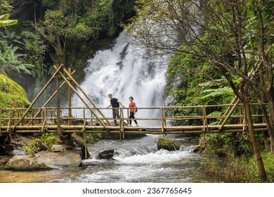 Couple seniors are walking on tropical forest trail in the outdoor recreation activities. - Powered by Shutterstock