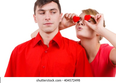 Couple. Serious Boyfriend And His Crazy Playful Girlfriend Holding Red Hearts Over Eyes. Valentines Day Or Unrequited Love Concept.