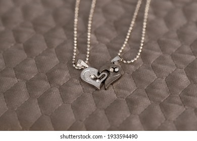 Couple Set Pendant Necklace Half Of Heart Shoot Outdoors In A Sunny Day Closeup. Selective Focus