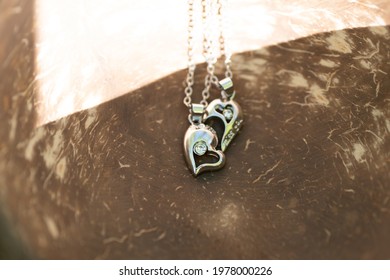Couple Set Pendant Necklace For Lovers Two Half Of A Heart Closeup. Selective Focus