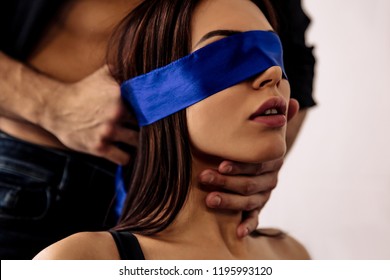 Couple. Sex. Role Play. Sexy Young Woman With A Blue Bandage On Her Eyes, Guy Is Touching Her Neck