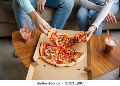 Couple Sharing Pizza And Eating