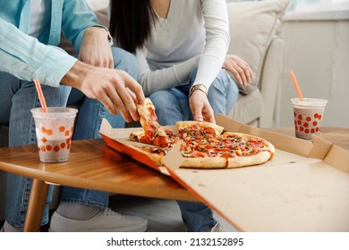 Couple Sharing Pizza And Eating