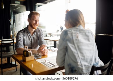 Couple sharing precious moments together in restaurant - Shutterstock ID 560189176