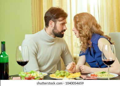 Couple Sharing Spaghetti. Romantic Man And Woman. Hungry For Love.