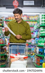 Couple Shocked On Comparing Product Price List At Grocery Store