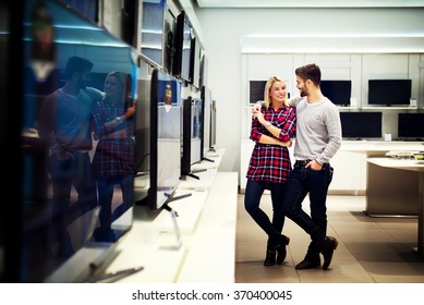 Couple In Shopping Looking For A New TV.