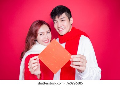 Couple Show Couplets With Chinese New Year On Red Background