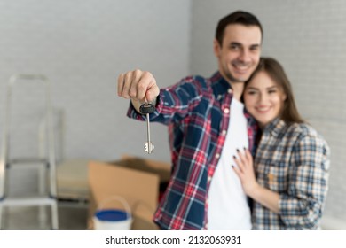 Couple showing keys to new home - Shutterstock ID 2132063931