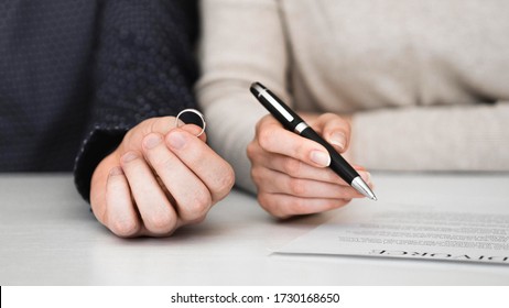 Couple signing divorce divorce settlement agreement. Separation contract document. - Shutterstock ID 1730168650