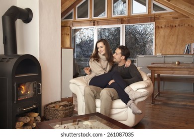 Couple Sitting By Fireplace