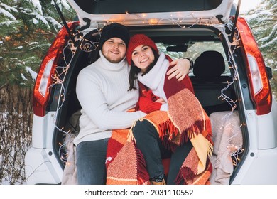 Couple Sitting In Car Trunk At Winter Time Love Story