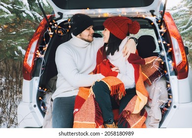 Couple Sitting In Car Trunk At Winter Time Love Story