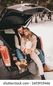 Couple Are Sitting In A Car In The Winter Forest