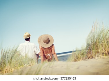 Couple Sitting Comfortable Beach Grass Holiday Concept