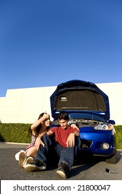 Couple Sitting Down After Car Break Down