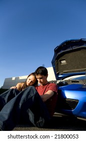 Couple Sitting Down After Car Break Down