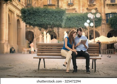 Couple Sitting On A Bench