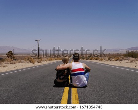 Couple sitting on highway in California, USA