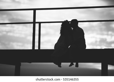 Couple Sitting On Wooden Bridge Looking Stock Photo 535146355 ...