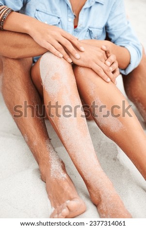 Couple, sitting and sand beach leg closeup or intimate summer romance, holiday vacation or sunshine lovers. Male, female or hug for sea feet or tropical bonding partnership, ocean relax or connection