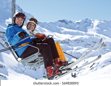 Couple Sitting In A Ski Lift