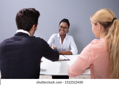 Couple Sitting And Talking At Interview At Adoption Agency