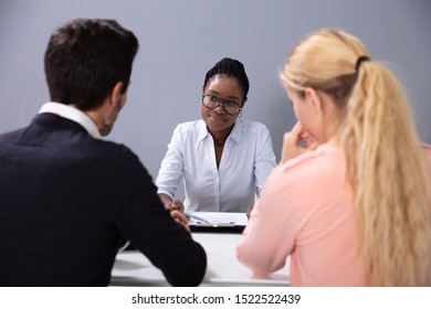 Couple Sitting And Talking At Interview At Adoption Agency