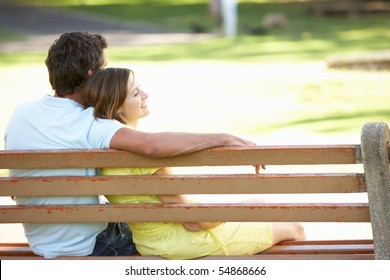 Couple Sitting Together On Park Bench