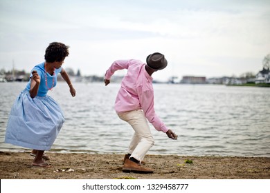 Couple Skimming Stones Together.