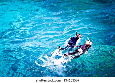 Couple Skorkelling On The Great Barrier Reef, Australia