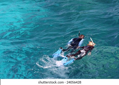 Couple Skorkelling On The Great Barrier Reef, Australia