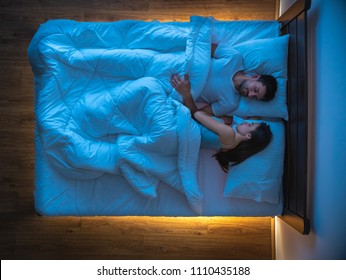 The Couple Sleeping On The Bed. View From Above, Evening Night Time