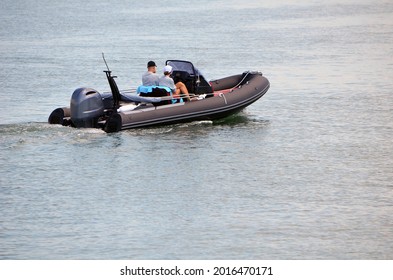 Couple Slowly Cruising On The Intra-Coastal Waterway In A Pontoon Motor Boat.