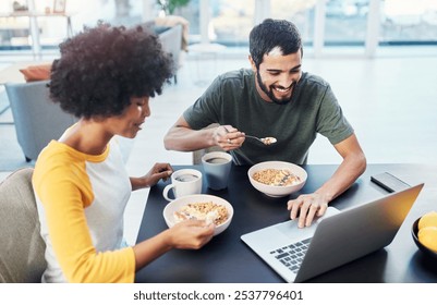 Couple, smile and eating breakfast in home for morning routine, nutrition and cereal with laptop. Interracial people, happy and porridge at dining table for wellness diet, start day and healthy food - Powered by Shutterstock