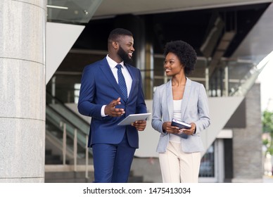 Couple Of Smiling African American Employees Friendly Chatting Outdoors, Copy Space