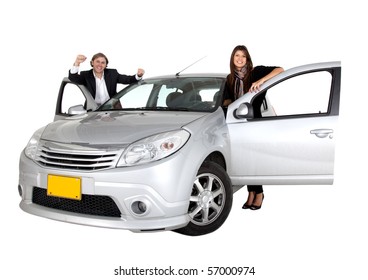 Couple Smiling With A Car Isolated Over A White Background