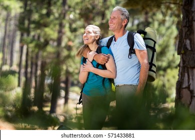 Couple smiling and holding each other on the wood