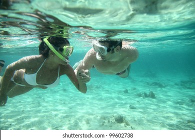 Couple Snorkeling In Caribbean Waters